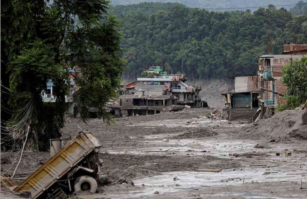 What triggered the catastrophic flood on the Nepal-Tibet border?