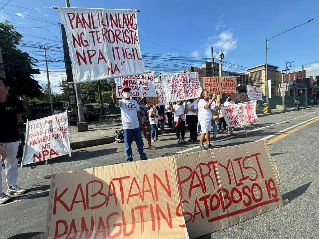 Ex-rebels, parents of students allegedly recruited by CPP-NPA protest in front of UP Diliman