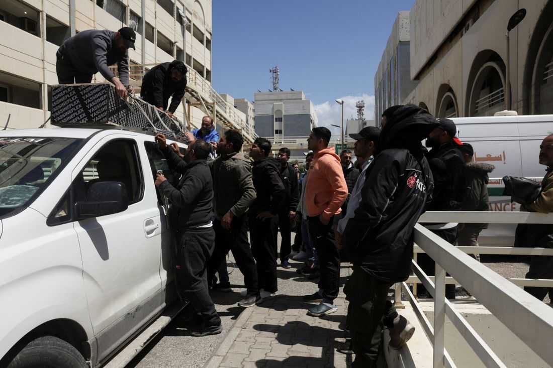 At Beirut hospital, grieving families identify mangled bodies after Israeli strikes