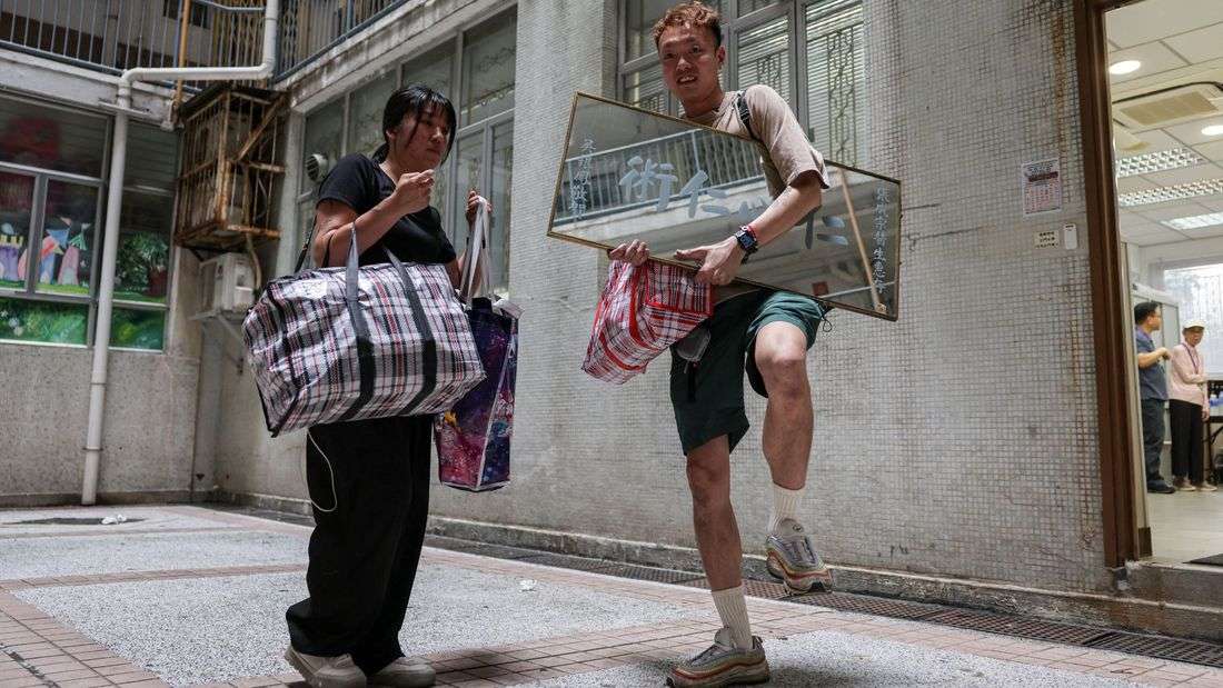 Back home, Hong Kong fire victim gathers memories from the ashes