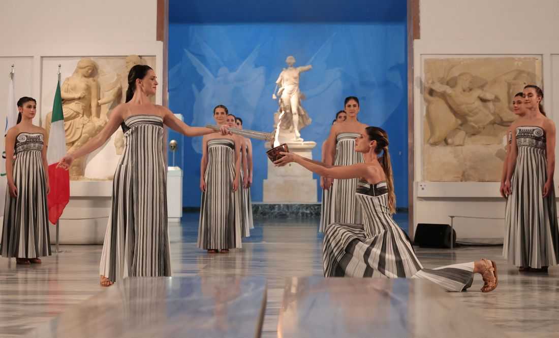 Torch for the Milano Winter Games lit in low-key indoor ceremony