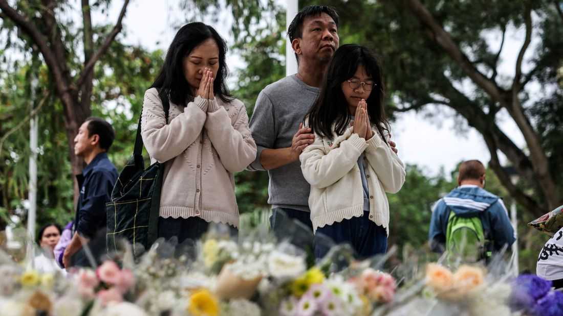 Mourners flock to site of deadly Hong Kong blaze as Beijing warns against protests