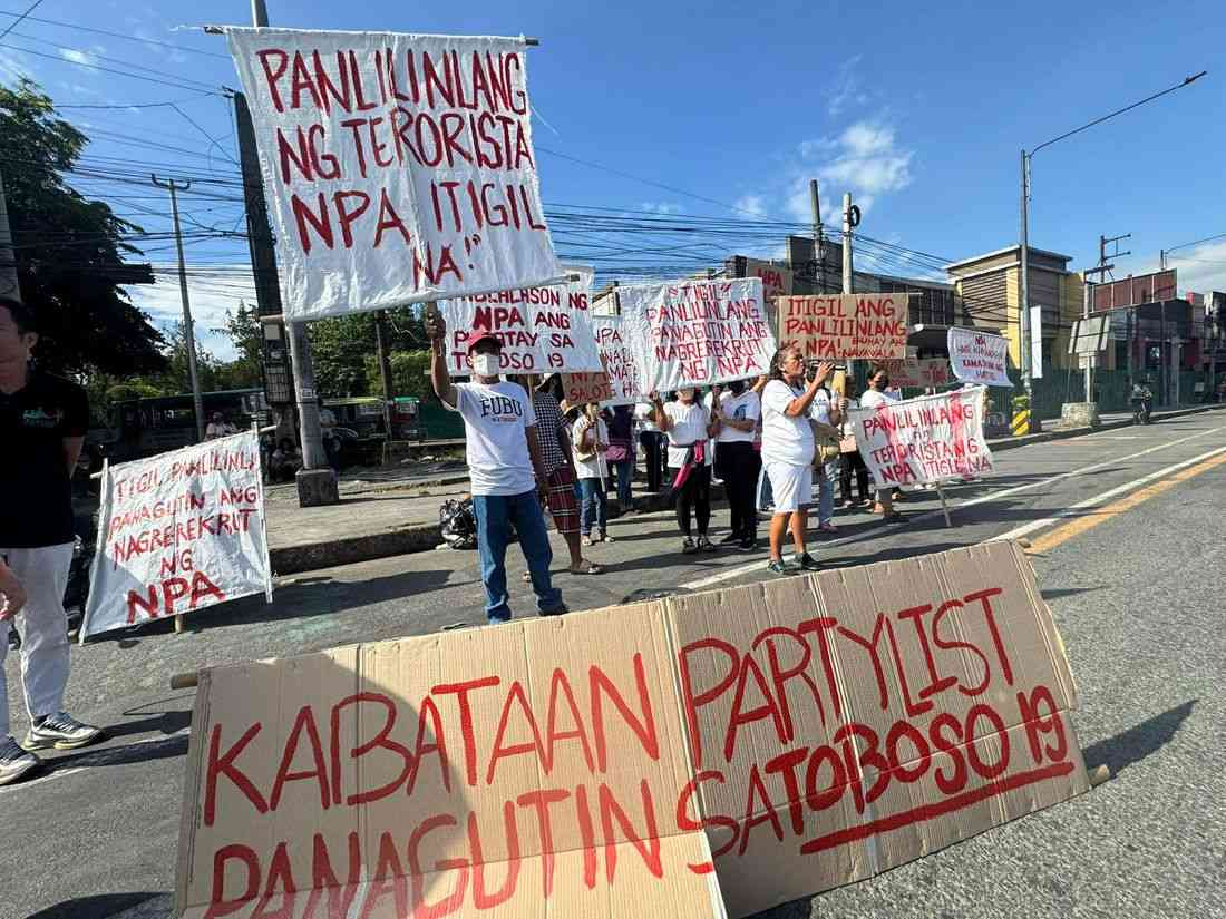Ex-rebels, parents of students allegedly recruited by CPP-NPA protest in front of UP Diliman