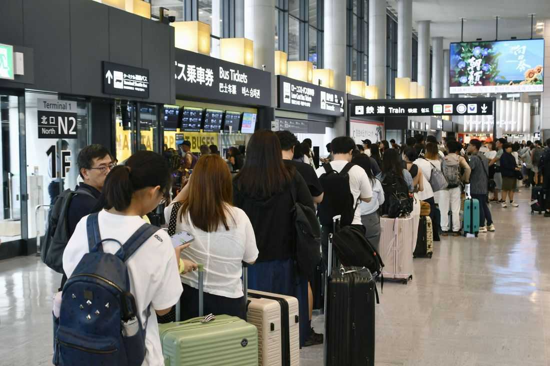Thousands stranded at Japan's Narita airport after record rain kills four