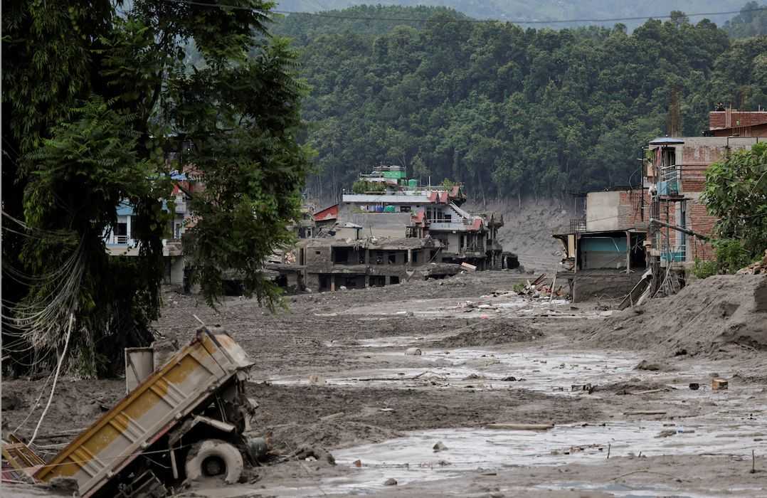 What triggered the catastrophic flood on the Nepal-Tibet border?