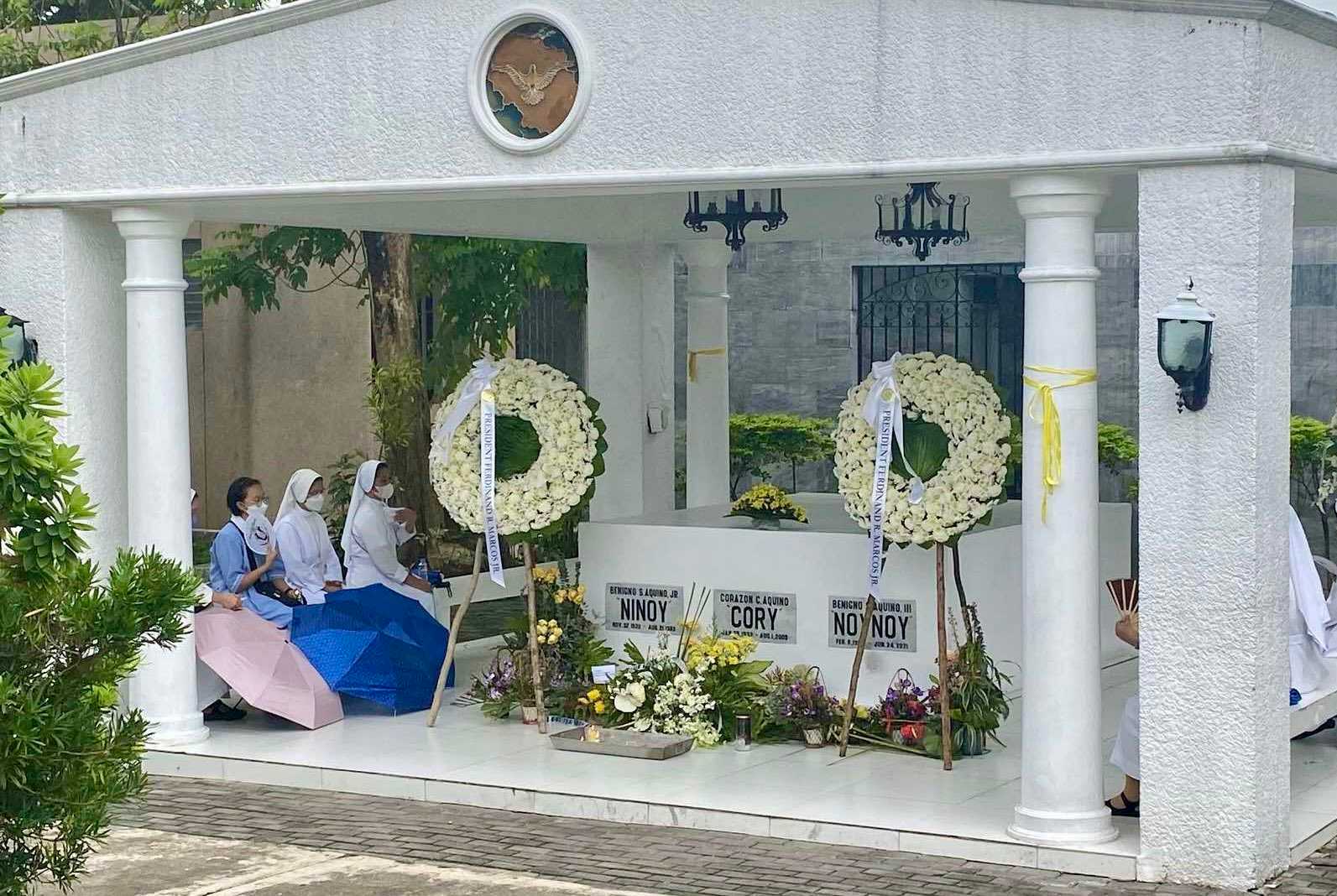 Marcos sends flowers to Aquino family's mausoleum at Manila Memorial Park