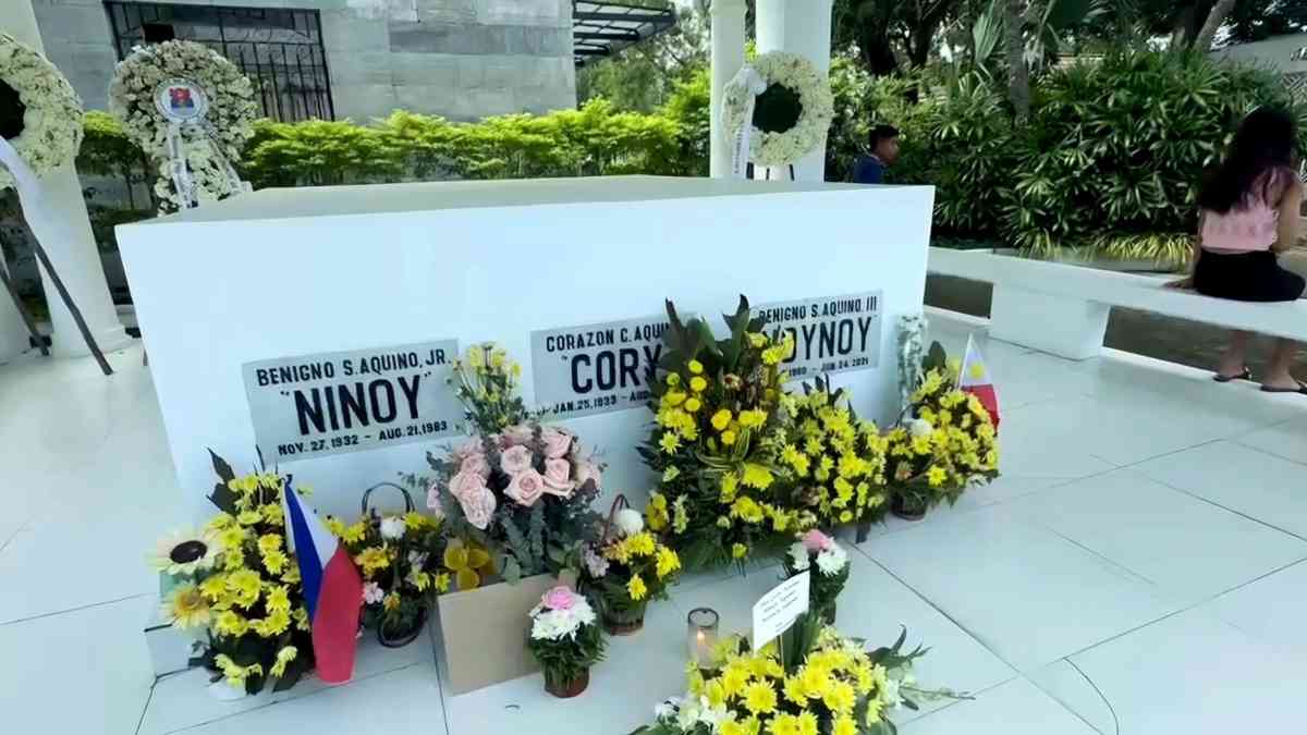 PBBM, supporters bring flowers, light candles at Aquino family mausoleum in Parañaque